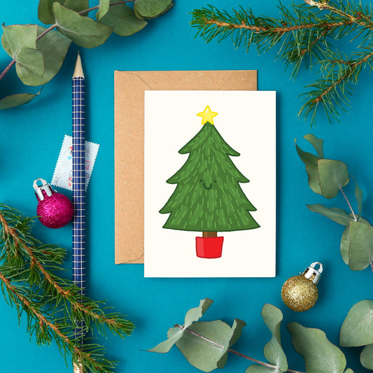Cute mini Christmas card featuring a smiling hand-drawn Christmas tree with a yellow star.