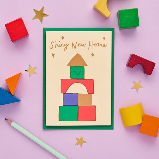 A Shiny New Home Card Featuring A Block Tower