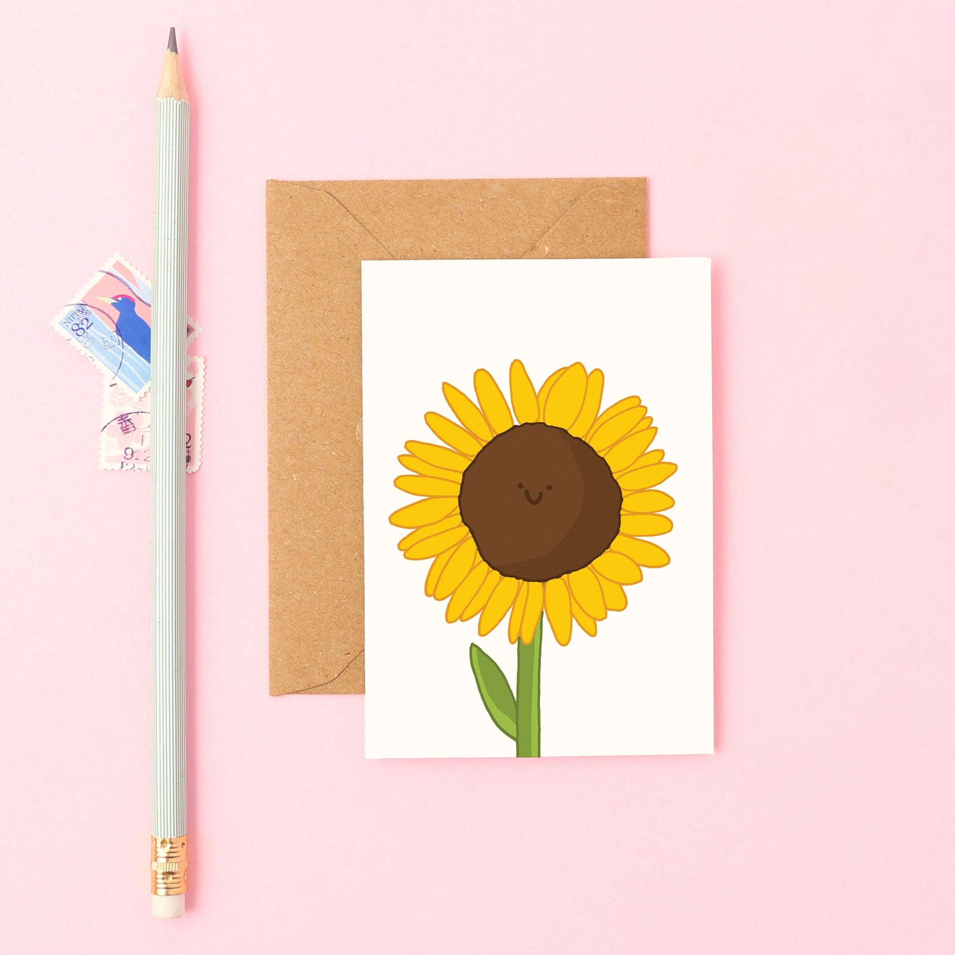 Hand-drawn sunflower with a happy face on a small greeting card. Great for thank you notes, summer displays, and cheering someone up.