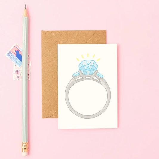 Mini A7 engagement ring card with smiling diamond ring illustration