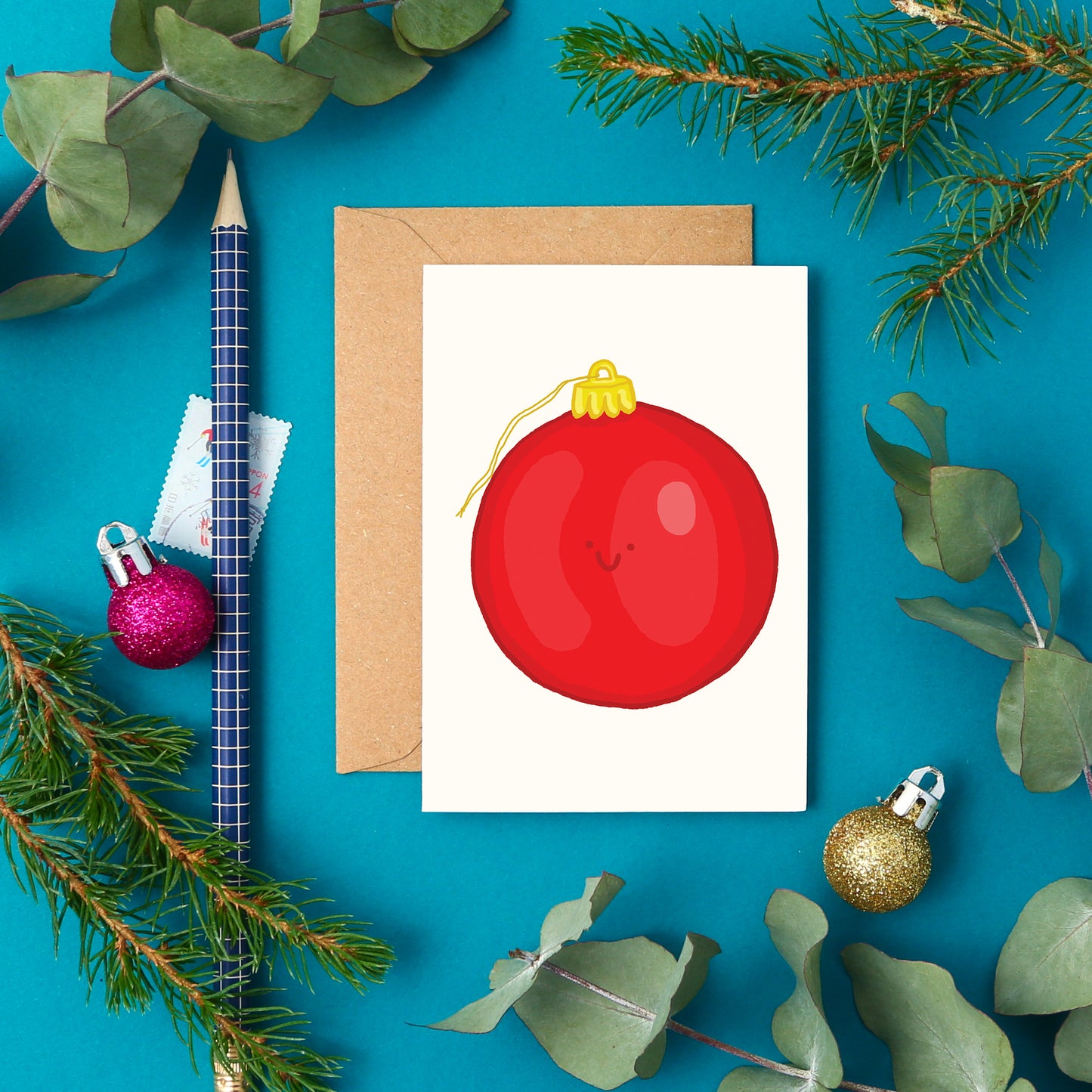 Mini festive greeting card with a hand-drawn red Christmas bauble and smiley face. Perfect for gift toppers