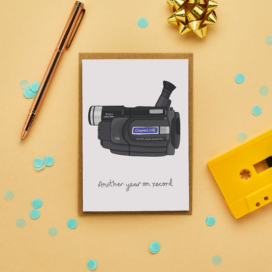 Retro birthday card with hand drawn camcorder and caption “Another year on record.”