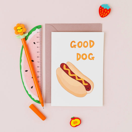 Good Dog greeting card featuring a smiling hot dog with gold foil lettering on a contemporary white background.