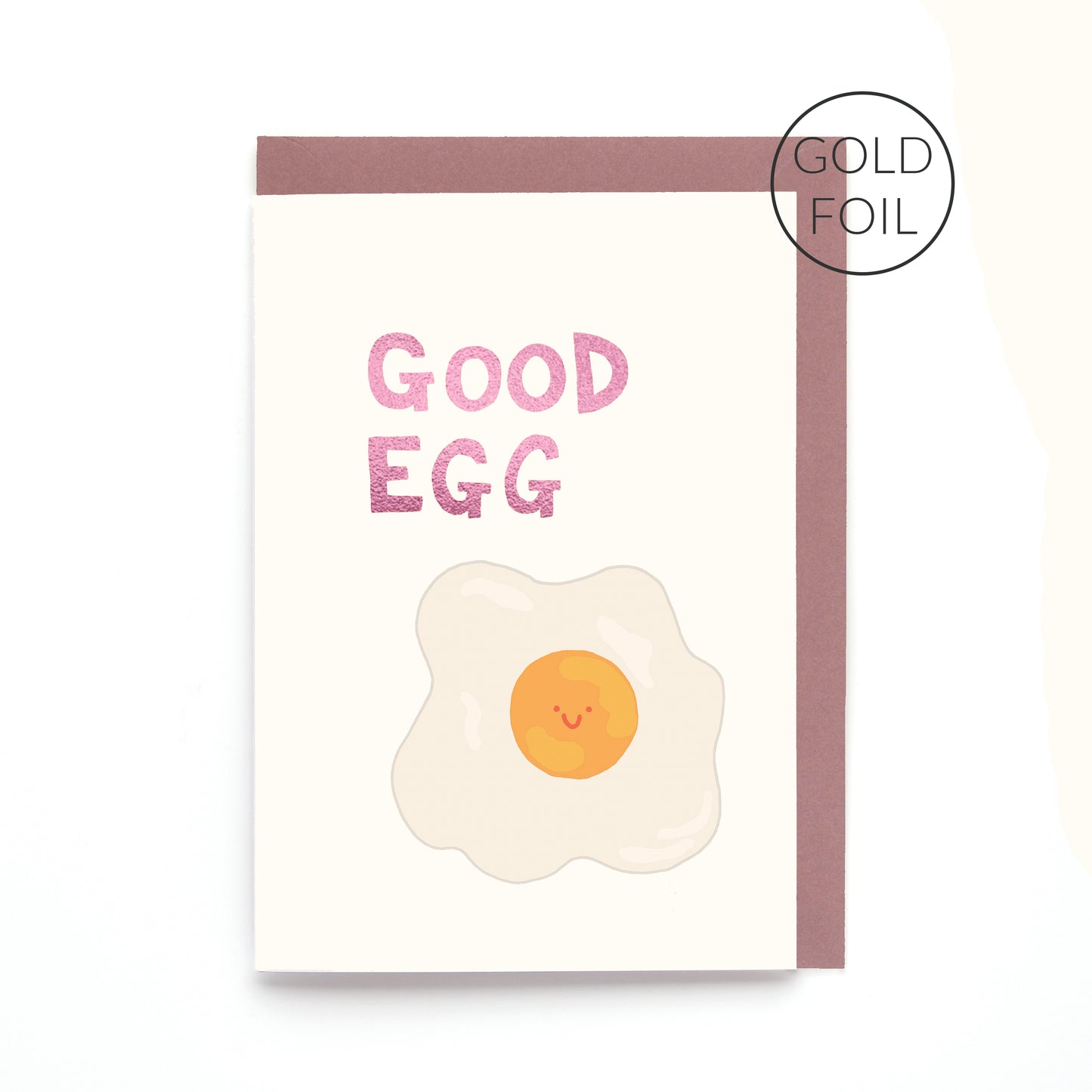 Good Egg greeting card featuring a smiling fried egg with pink foil lettering on a contemporary white background.