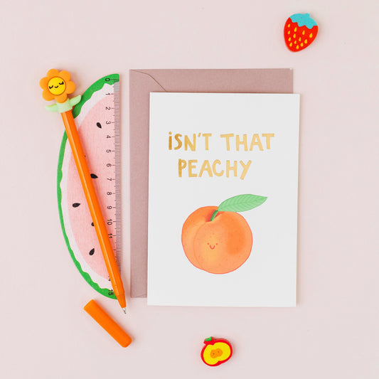Isn't That Peachy greeting card featuring a smiling peach with gold foil lettering on a contemporary white background.