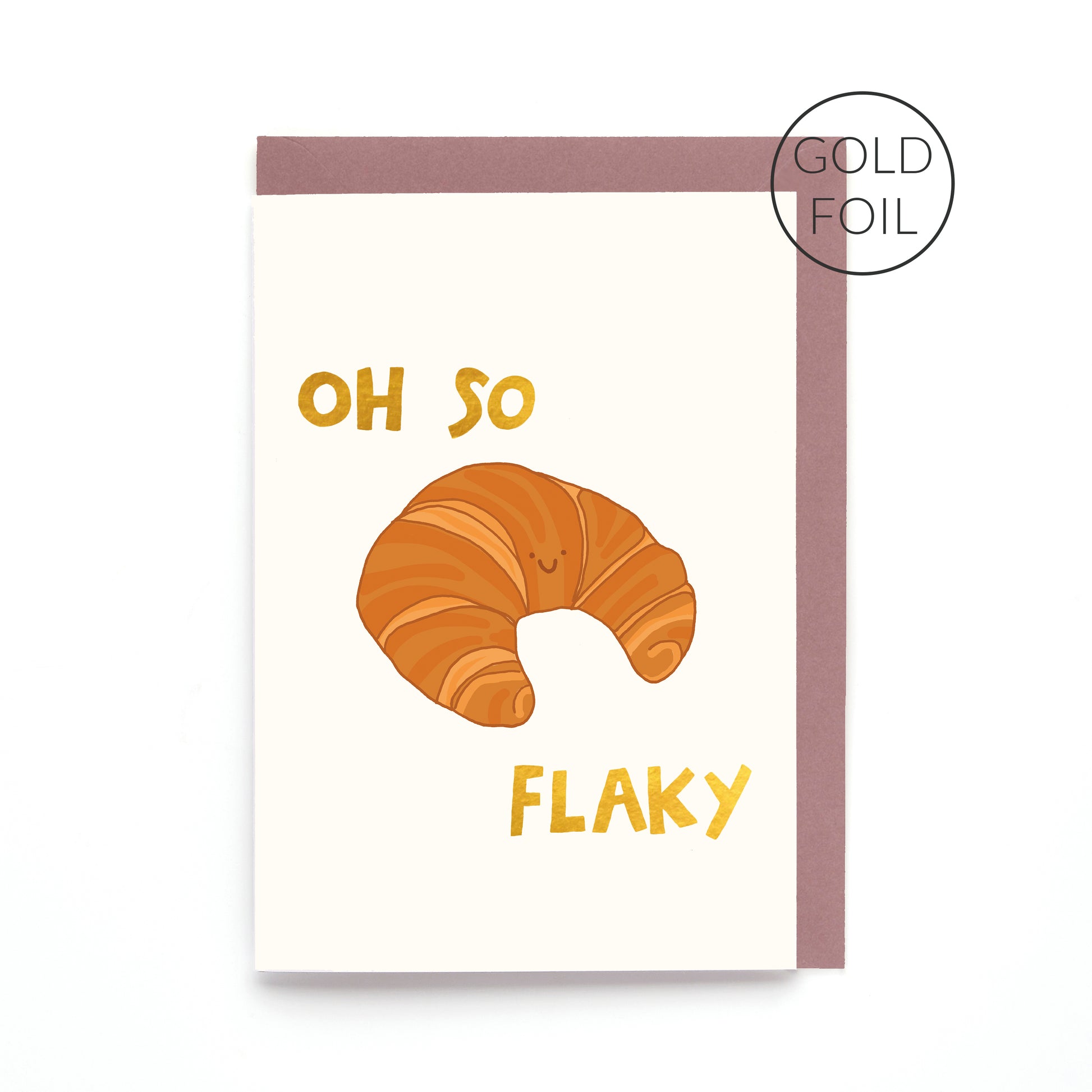 Oh So Flaky greeting card featuring a smiling croissant with gold foil lettering on a contemporary white background.