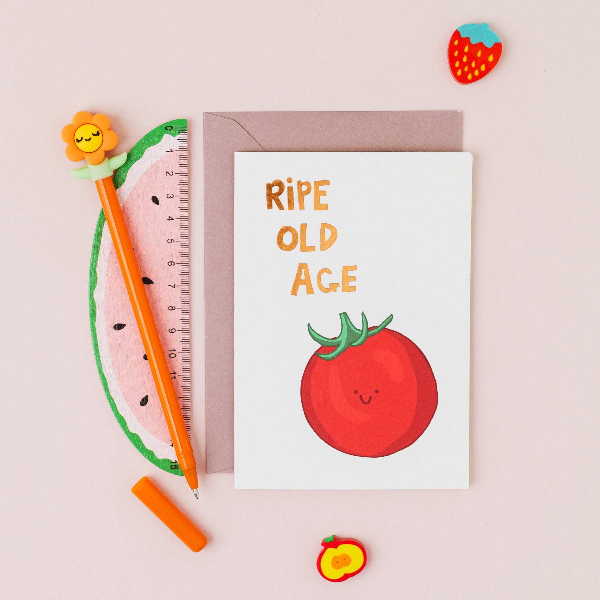 Ripe Old Age birthday card featuring a smiling tomato with gold foil lettering on a contemporary white background.