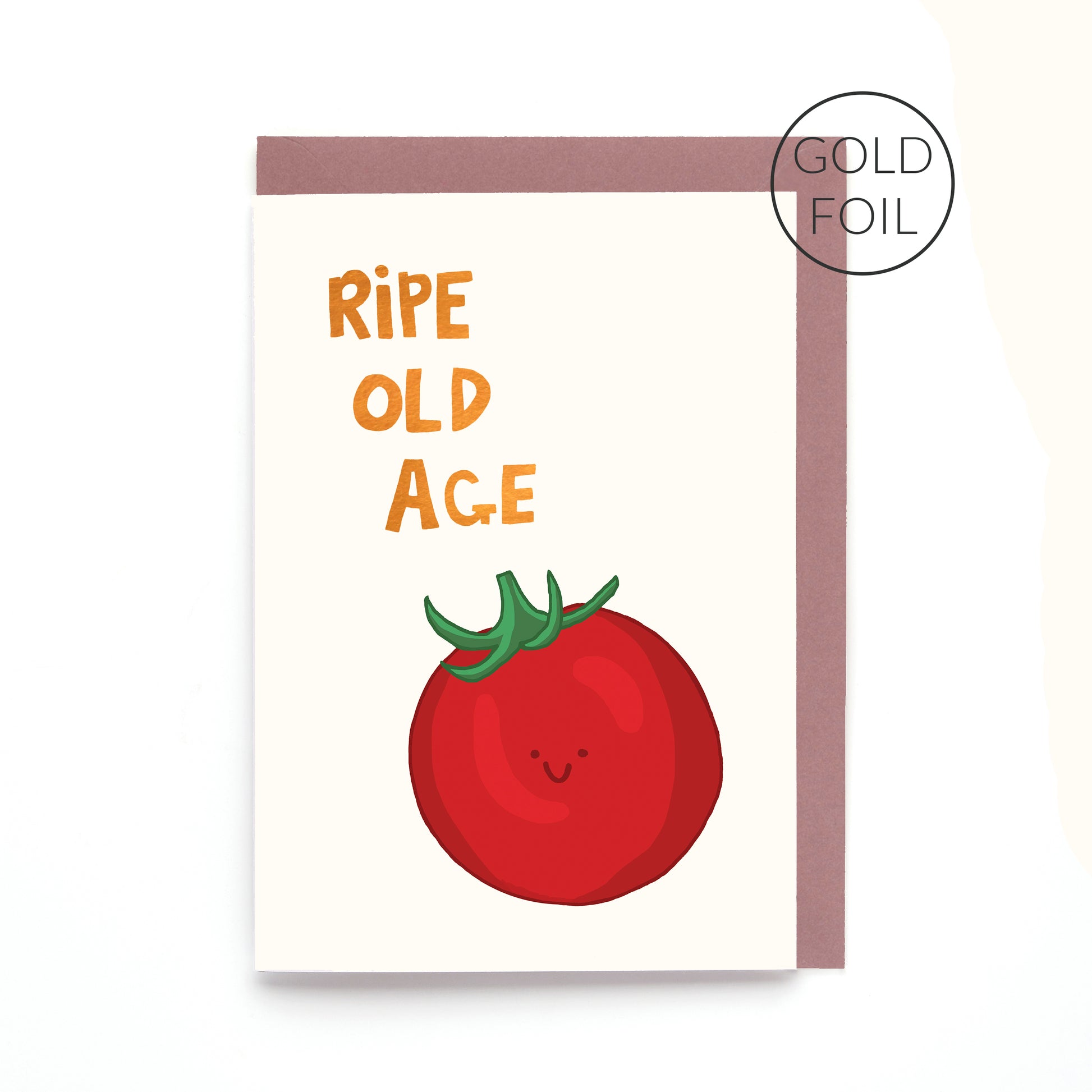 Ripe Old Age birthday card featuring a smiling tomato with gold foil lettering on a contemporary white background.