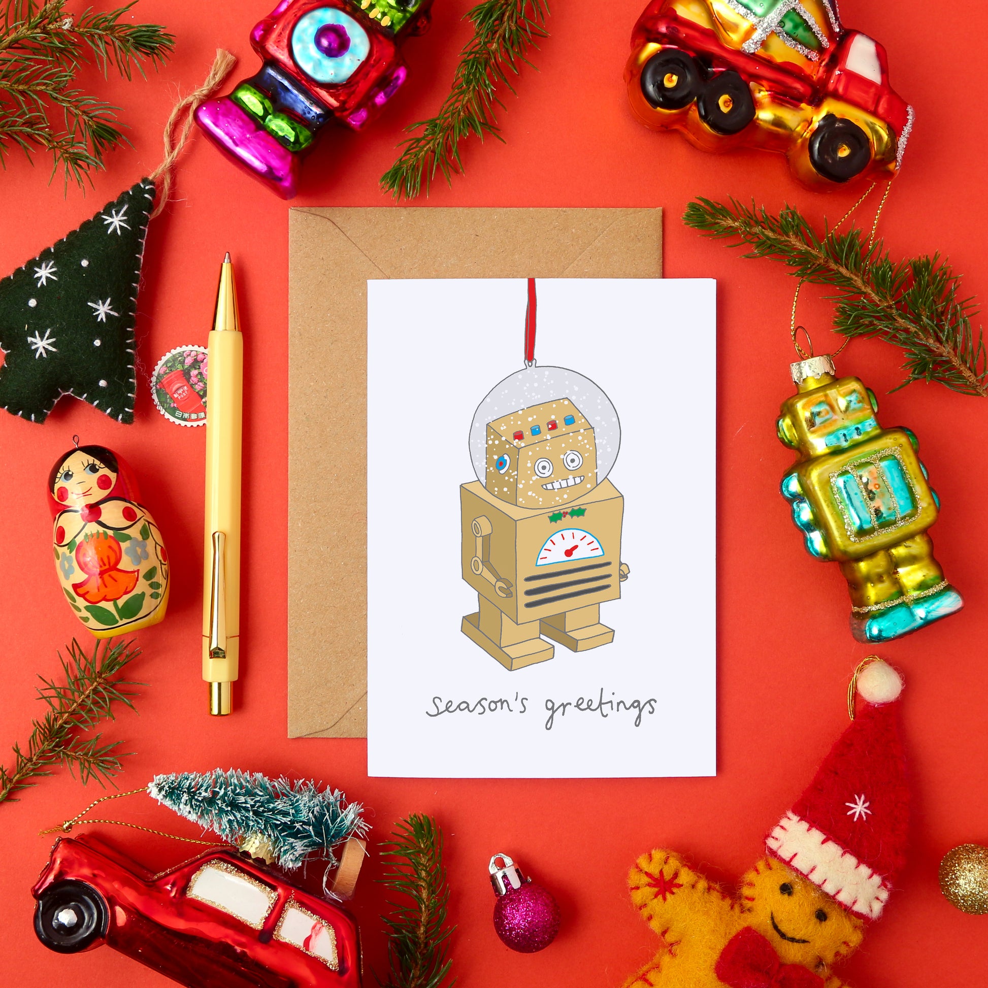 A Quirky Christmas Card Featuring a Robot Snow Globe Tree Decoration