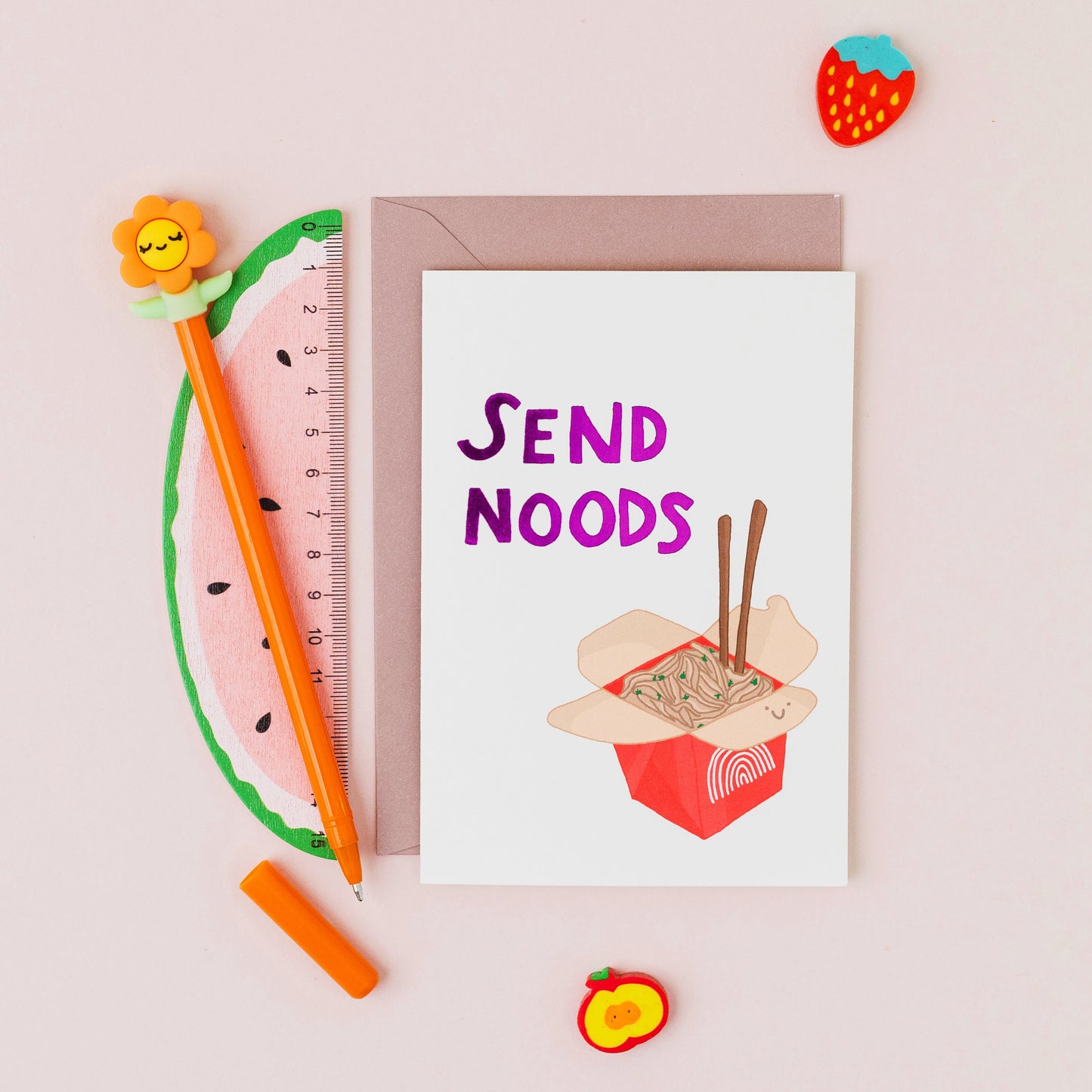 Send Noods greeting card featuring a smiling takeaway noodle box with gold foil lettering on a white background.