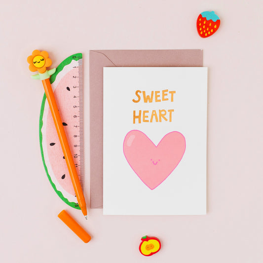 Hand drawn pink heart greeting card with the words 'Sweet Heart' in gold foil on a white background.
