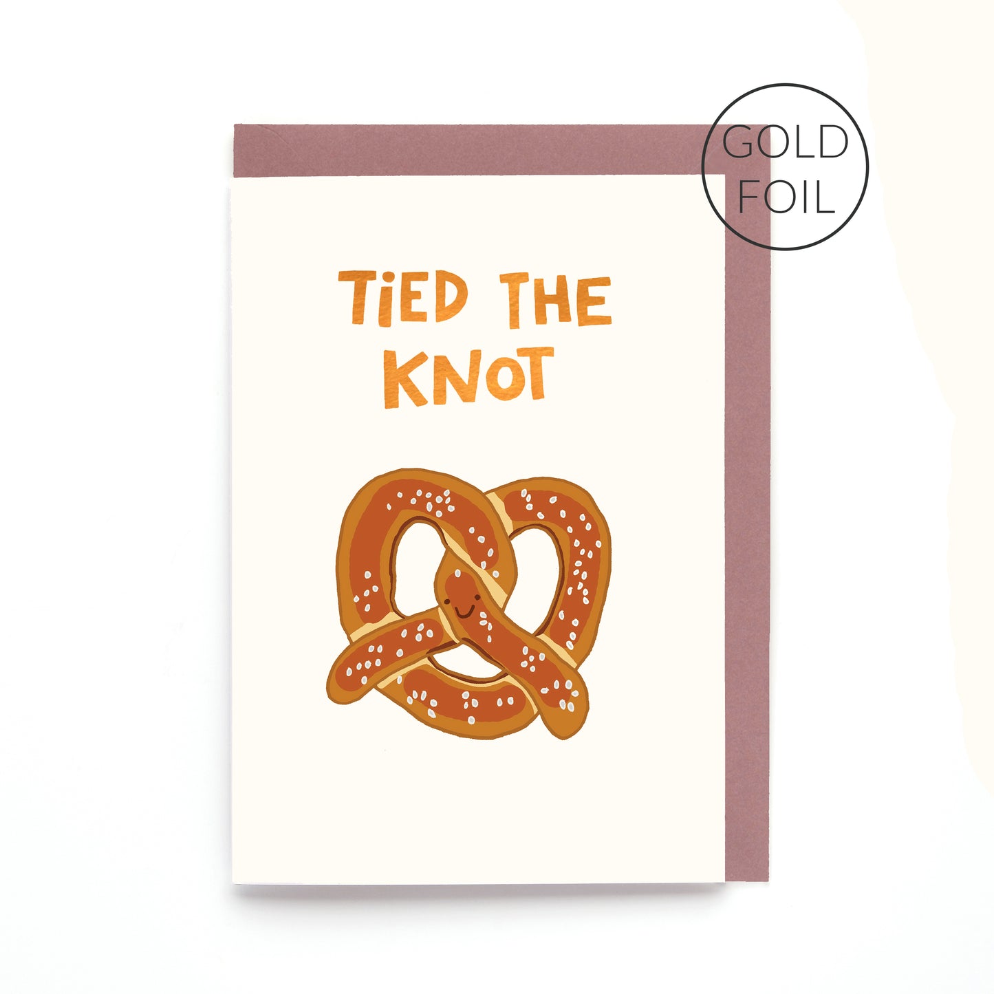 Hand drawn pretzel wedding greeting card with the words 'Tied The Knot' in gold foil on a white background.