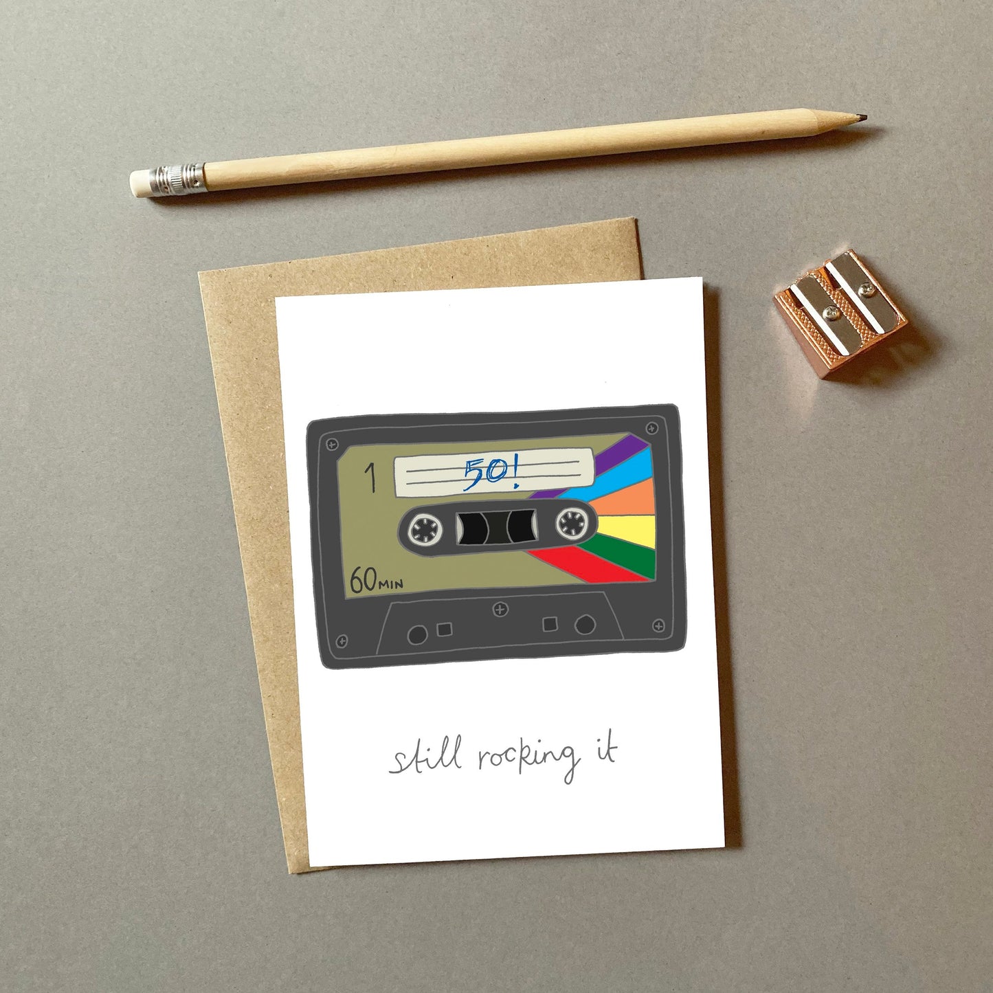 A retro 50th birthday card with an illustration of a cassette