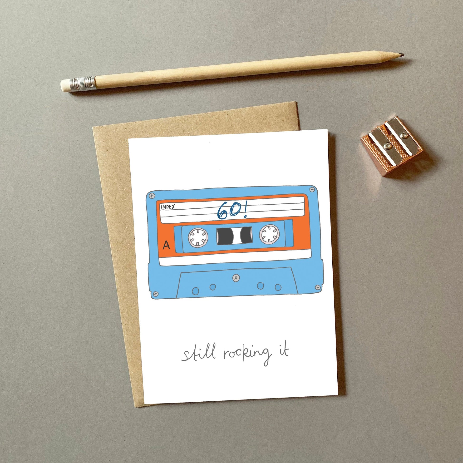 A retro 60th birthday card with an illustration of a cassette